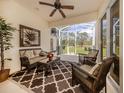 Relaxing screened lanai with comfortable seating and scenic views of the lush backyard at 29692 Niagara Ct, Englewood, FL 34223