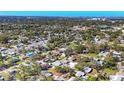 An aerial view of a residential neighborhood with lush greenery and a mix of single-Gathering homes near the water at 3052 Alta Vista St, Sarasota, FL 34237