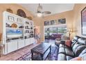 Living room boasts built-in shelving, neutral paint, and an oversized opening to the screened lanai at 311 Pembroke Dr # 217, Venice, FL 34293