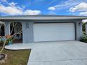 Exterior view of the home with a white garage door and a covered entryway with brick flooring at 3278 Terita Dr, Port Charlotte, FL 33952