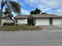 Charming single-story home with a two-car garage and manicured landscaping at 404 Elder St # 230, Englewood, FL 34223