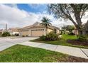 Well-maintained home featuring a three car garage, lush landscaping and a welcoming driveway at 4301 Whispering Oaks Dr, North Port, FL 34287