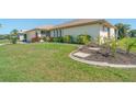 Single-story house with well-maintained lawn, mature landscaping and a concrete curb at 5875 Jackson, Venice, FL 34293