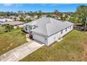 Aerial view of the home showcases the neutral color, well-maintained lawn, and convenient driveway at 6231 Pecan Rd, Venice, FL 34293