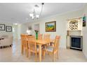 Dining room with a wooden table, wine cooler, modern lighting, and tile floors at 705 Cadiz Rd, Venice, FL 34285
