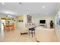 Bright living room featuring tile floors, modern furniture, and recessed lighting at 705 Cadiz Rd, Venice, FL 34285