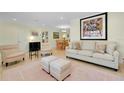 Relaxing living room featuring tile floors, comfortable furniture, and recessed lighting at 705 Cadiz Rd, Venice, FL 34285