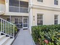 Close up of the unit entrance with table and chairs visible through the screened lanai at 800 Gardens Edge Dr # 814, Venice, FL 34285