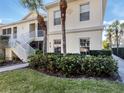 Beautiful condo exterior with lush landscaping, a manicured lawn, and a sidewalk to the front door at 800 Gardens Edge Dr # 814, Venice, FL 34285