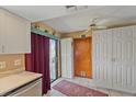 Bright kitchen area with updated appliances, white cabinets, and a door leading to the backyard at 8155 Mossborger Ave, North Port, FL 34287