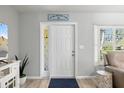 Bright foyer featuring a white front door, and modern decor at 929 The Rialto, Venice, FL 34285