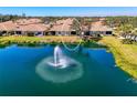 Lakefront backyard view with soothing fountain feature and lush green space at 1022 Yosemite Dr, Englewood, FL 34223
