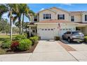 Lovely two-story townhome features an attached garage and a beautifully paved driveway, providing ample parking and curb appeal at 1050 Jonah Dr, North Port, FL 34289