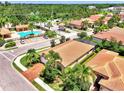 Beautiful home near community pool with lush landscaping, screened patio, and brick driveway at 1088 Bluffwood Dr, Nokomis, FL 34275