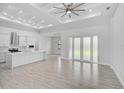 Living room featuring wood-look tile floors, an open layout, and access to the kitchen at 1131 Chalmer Ter, Port Charlotte, FL 33953