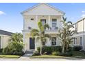 Charming two-story home with a welcoming front porch and lush tropical landscaping at 12679 Sagewood Dr, Venice, FL 34293