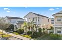 Attractive two-story home with a quaint front porch surrounded by a lush green lawn at 12679 Sagewood Dr, Venice, FL 34293