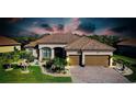 Beautiful single-story home with a brick driveway, two-car garage, and well-manicured landscaping at 13652 Classico Ct, Venice, FL 34293