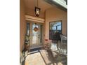 Inviting front porch with a comfortable chair and decorative accents for a cozy welcome at 13652 Classico Ct, Venice, FL 34293