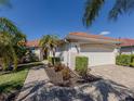 Charming home boasting a tile roof, well-manicured landscaping, and a welcoming two-car garage at 162 Treviso Ct, North Venice, FL 34275