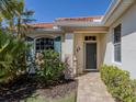 Inviting front entrance featuring a well-kept garden and a charming entryway door at 162 Treviso Ct, North Venice, FL 34275