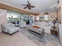 Bright living room with a ceiling fan, tile flooring, and comfortable seating at 162 Treviso Ct, North Venice, FL 34275