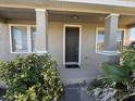 Home's front entrance with neutral paint, decorative windows and lush landscaping at 17370 Cape Horn Blvd, Punta Gorda, FL 33955