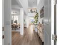 Bright, open entryway with wood floors, staircase, and view into the living spaces at 17449 Luminous Ave, Venice, FL 34293