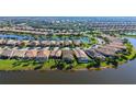 Wide aerial shot of the real estate with water view and meticulously maintained neighborhood and community at 19651 Quisto St, Venice, FL 34293