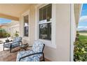 Relaxing front porch featuring comfortable seating and views of the surrounding landscape at 20389 Minuet Pl, Venice, FL 34293