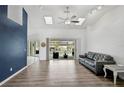 Open living room with vaulted ceilings, wood floors, and sliding doors to the pool at 2114 S Biscayne Dr, North Port, FL 34287