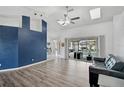 Bright living room with vaulted ceilings, wood floors, and sliding doors to the lanai at 2114 S Biscayne Dr, North Port, FL 34287
