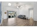 Bright living room with vaulted ceilings, wood floors, and sliding doors to the lanai at 2114 S Biscayne Dr, North Port, FL 34287