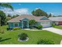 Beautiful one-story home with a well-kept lawn, mature landscaping, and a welcoming front entrance at 213 Bayside Ct, Nokomis, FL 34275