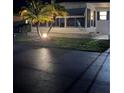 Charming single-story home with manicured lawn at night at 218 Palm Air Dr, Osprey, FL 34229
