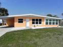 Inviting single-story home featuring a front yard, carport, and well-maintained landscaping at 231 Redwood Rd, Venice, FL 34293