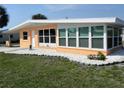 Lovely single-story home, showcasing the lush green lawn and complemented by white rock landscaping at 231 Redwood Rd, Venice, FL 34293