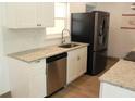 Modern kitchen featuring granite countertops, stainless steel appliances, and ample natural light at 231 Redwood Rd, Venice, FL 34293