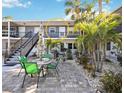 Cozy patio with outdoor seating, surrounded by tropical landscaping, perfect for relaxing in this condo community at 236 Harbor S Dr # 202, Venice, FL 34285