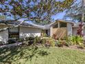 Charming single-story home with a landscaped front garden and a mature tree at 268 Southampton Dr # 309, Venice, FL 34293