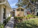 Inviting front entrance with landscaped garden beds and a charming walkway to the front door at 268 Southampton Dr # 309, Venice, FL 34293