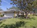 Charming single-story home with a well-manicured lawn and mature tree in the front yard at 268 Southampton Dr # 309, Venice, FL 34293