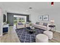 Cozy living room featuring stylish furnishings, modern decor, and a sliding glass door with a picturesque view at 275 Mission W Trl # G, Venice, FL 34285