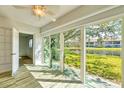 Bright sun room with sliding glass doors and beautiful lake views, perfect for relaxation and enjoying the scenery at 275 Mission W Trl # G, Venice, FL 34285