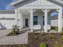 Beautifully landscaped front porch with modern columns and a stylish entrance at 29176 Coral Harbour Dr, Englewood, FL 34223