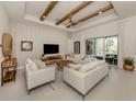 Inviting living room with vaulted ceilings, wood beams, and stylish furniture at 29176 Coral Harbour Dr, Englewood, FL 34223