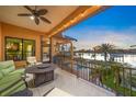 Relaxing balcony with outdoor seating area overlooking the water, perfect for enjoying the sunset at 471 Bayshore Rd, Nokomis, FL 34275