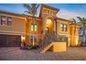 Attractive exterior showcasing a brick driveway, manicured landscaping, and beautiful staircase at 471 Bayshore Rd, Nokomis, FL 34275