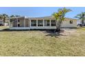Spacious backyard featuring a screened-in lanai perfect for enjoying outdoor living at 501 Dona Dr, Nokomis, FL 34275