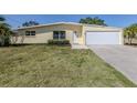 Inviting single-story home with a manicured lawn, clean lines, and a two-car attached garage at 501 Dona Dr, Nokomis, FL 34275